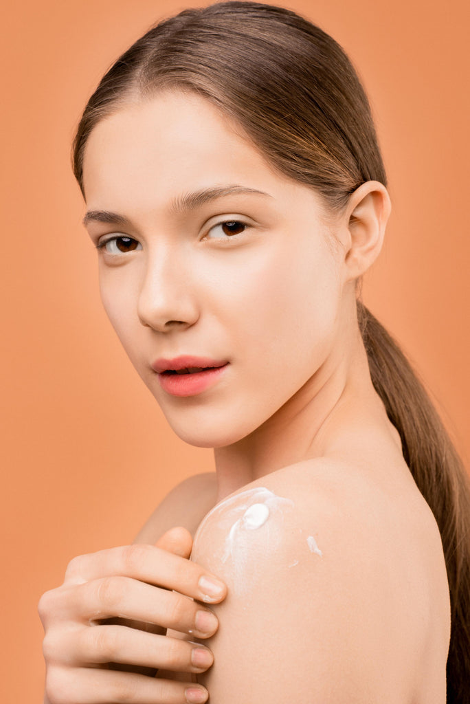 Female applying skincare product to her skin